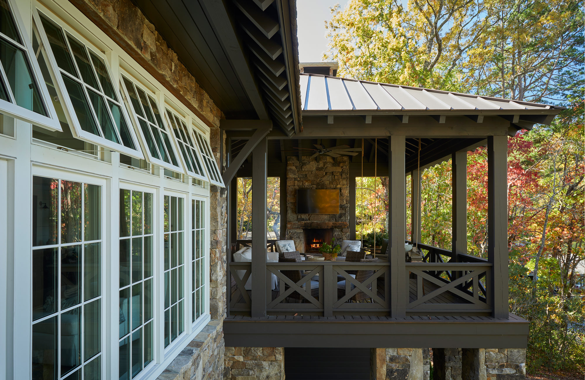 metal roof, lake house, stone walls, outdoor fireplace